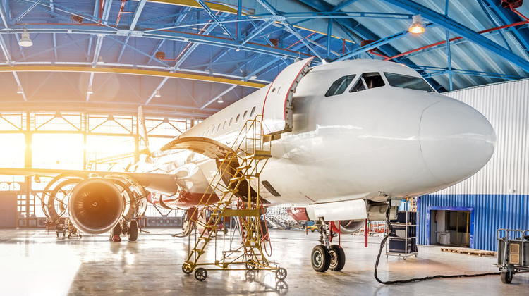 Maintenance and repair of aircraft in the aviation hangar of the airport, view of a wide panorama