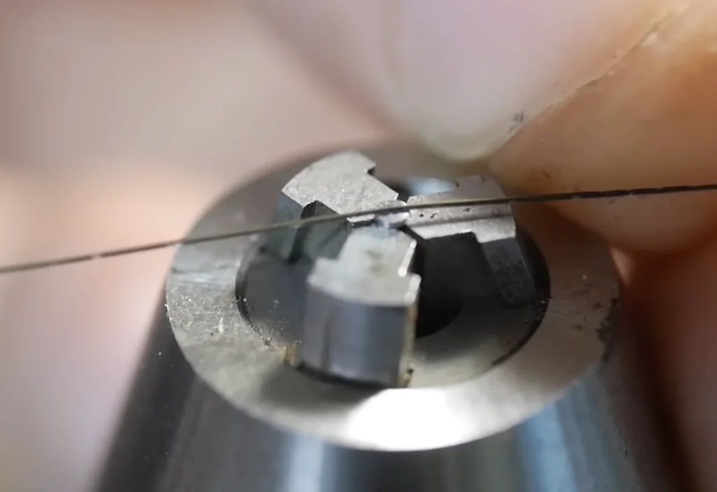 The head slot was manually cut with a piercing saw fixed in a pin vise or tailstock chuck